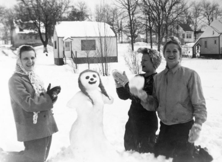 Snowmen Young Women Playing In Snow Building Snowman